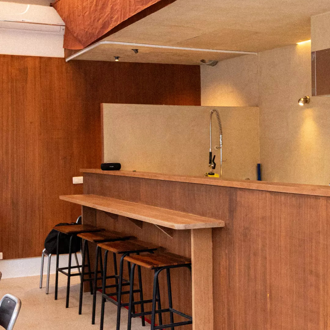 Modern kitchen with wooden bar and stools